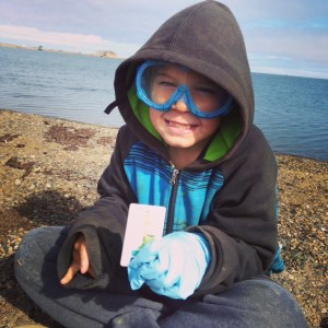 Troy demonstrates proper safety gear while analyzing water for pollutants